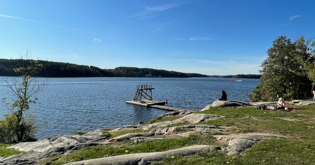 A lakeshore under a blue sky