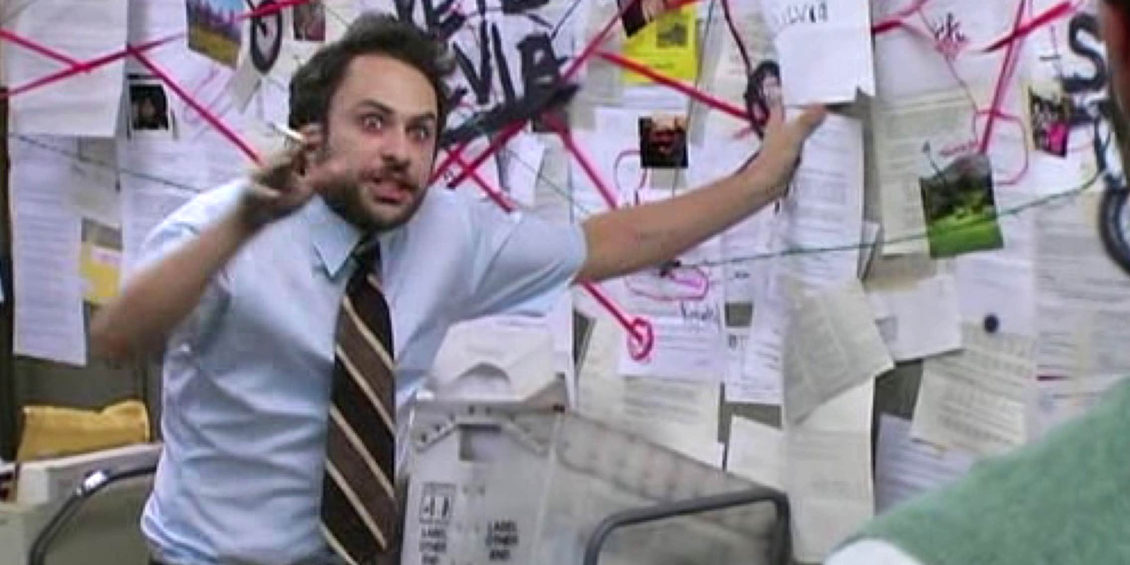 Charlie Day gestures wildly in front of a board with papers connected by a web of red string