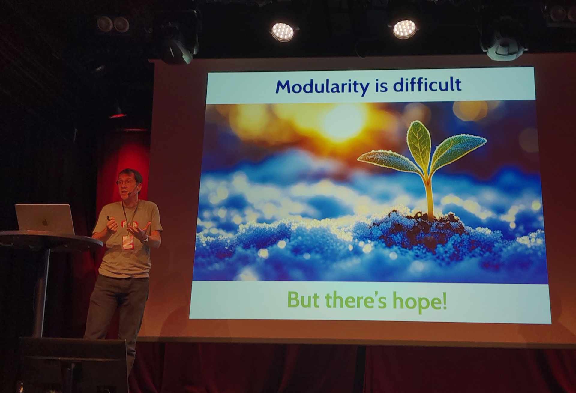 Eric presents a slide labelled "Modularity is difficult, but there's hope!"