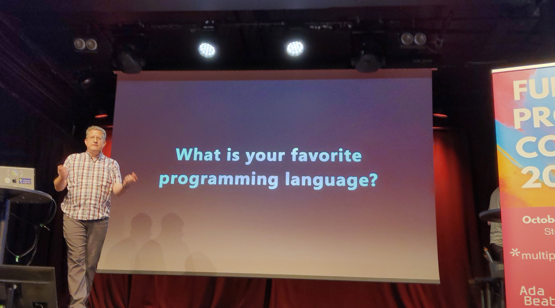Christoph presents a slide labelled "What is your favorite programming language?"