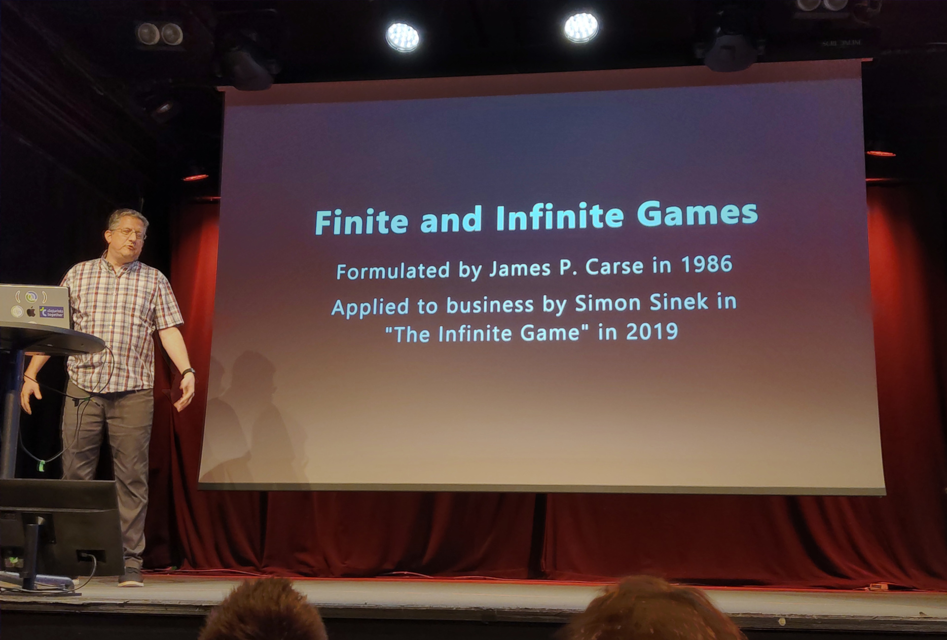 Christoph presents a slide labelled "Finite and Infinite Games"