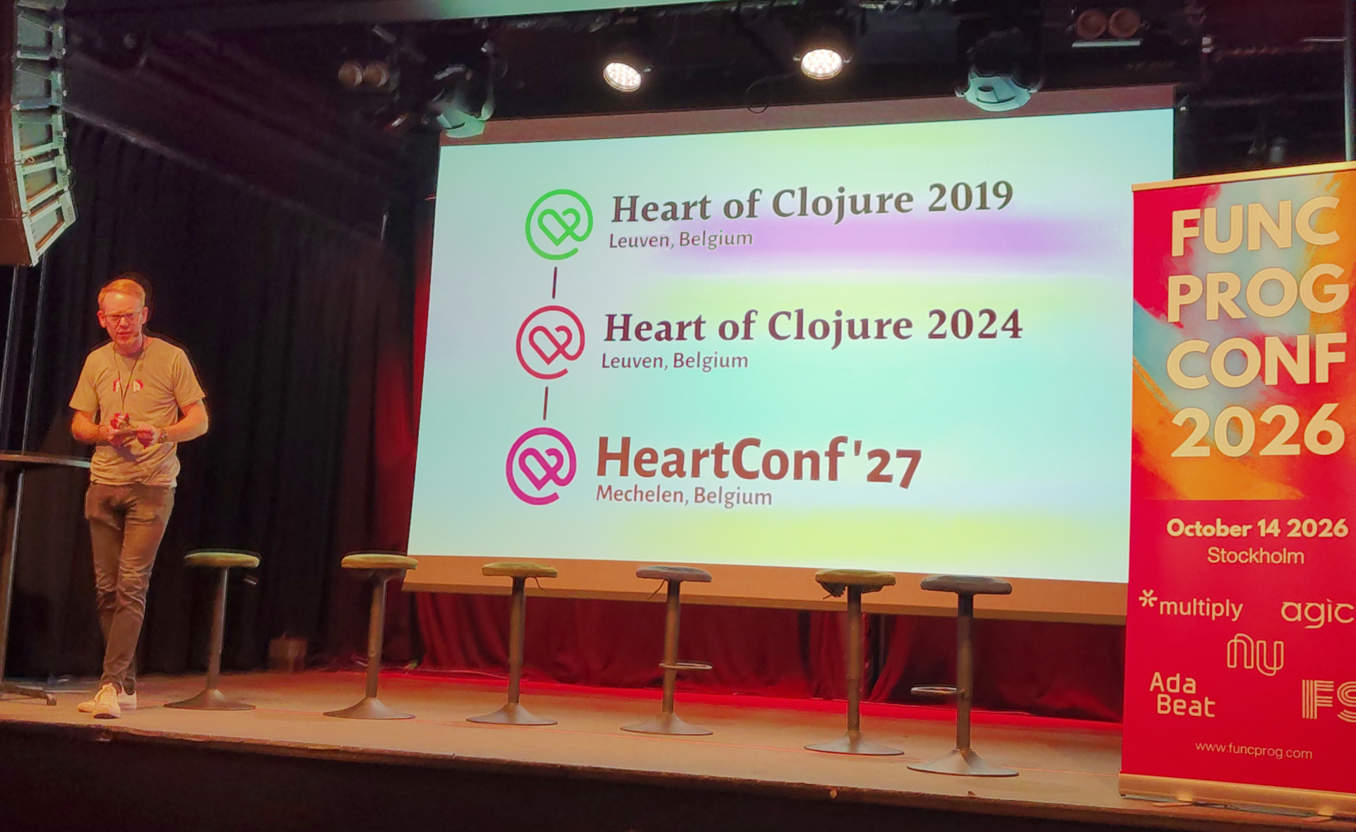 Christoffer in front of a slide displaying the lineage of HeartConf