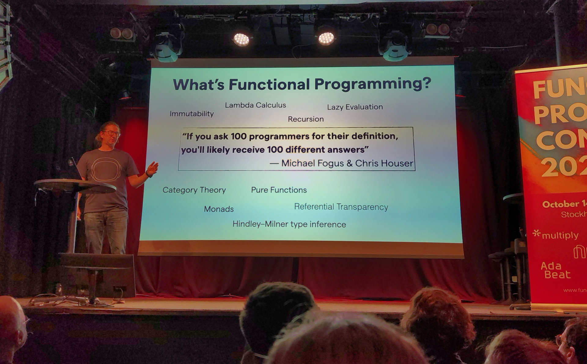 Adam presents a slide labelled "What's Functional Programming"