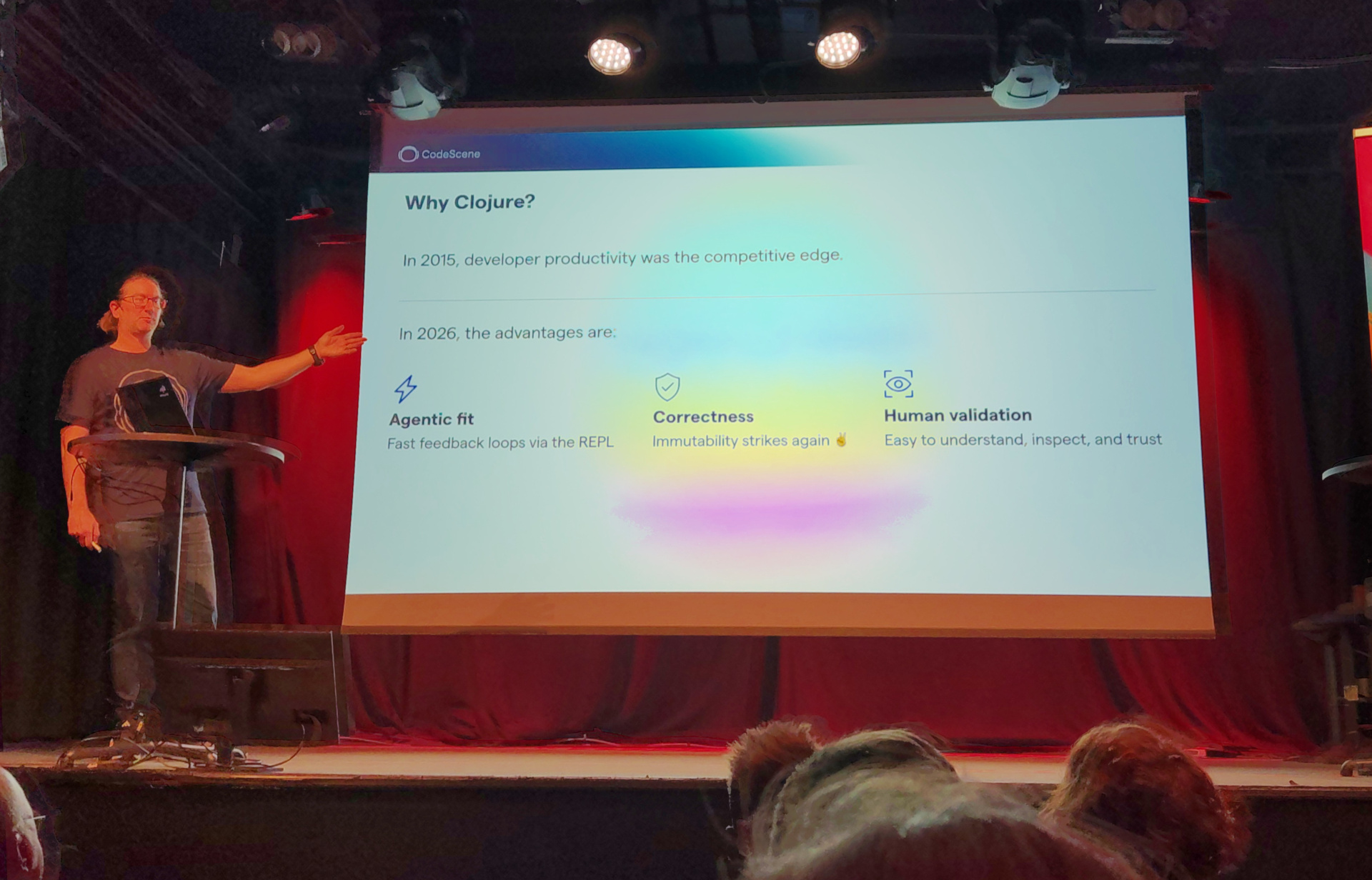 Adam presents a slide labelled "Why Clojure?"